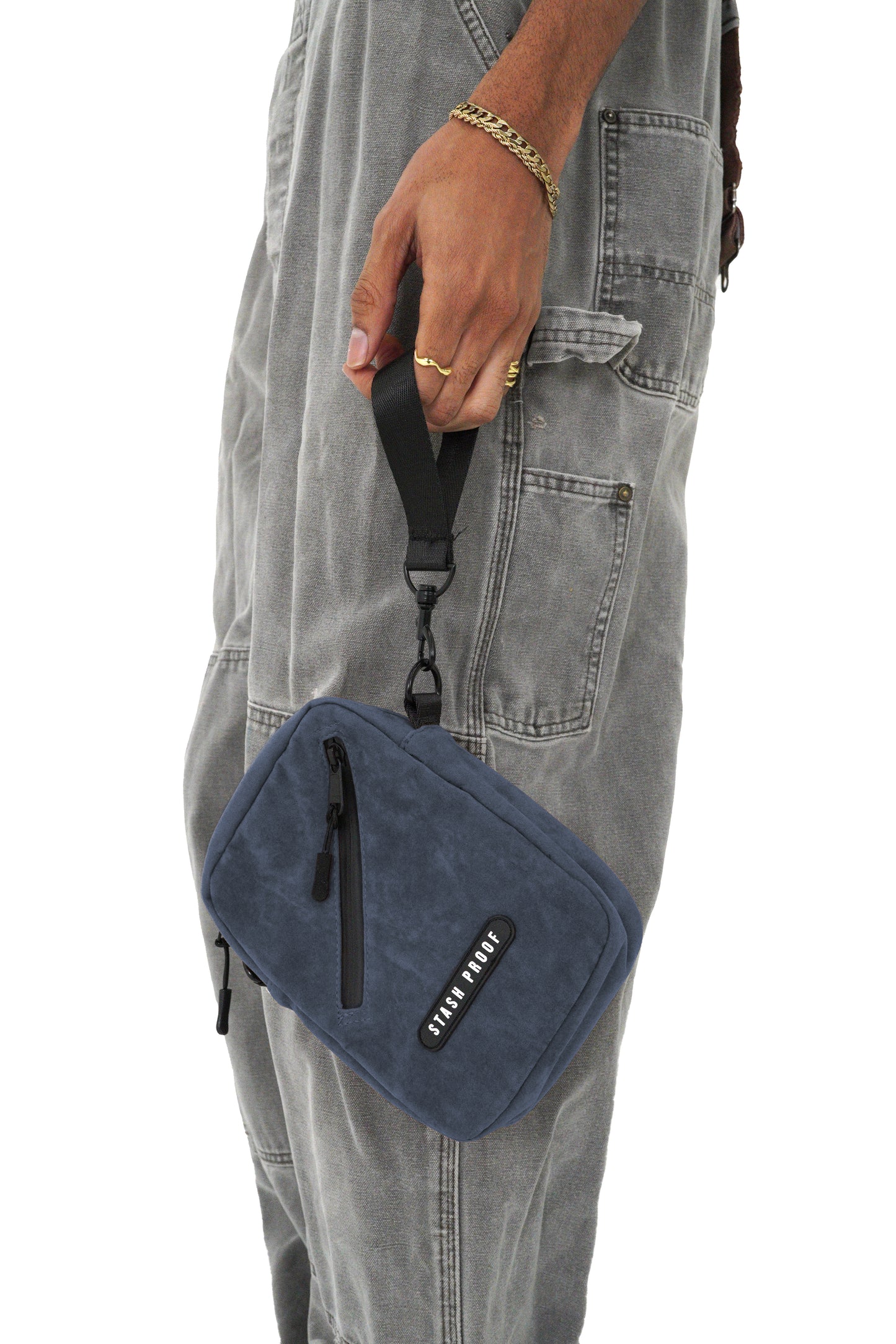 Model picture from waist down holding the blue suede Stash bag by carrying strap