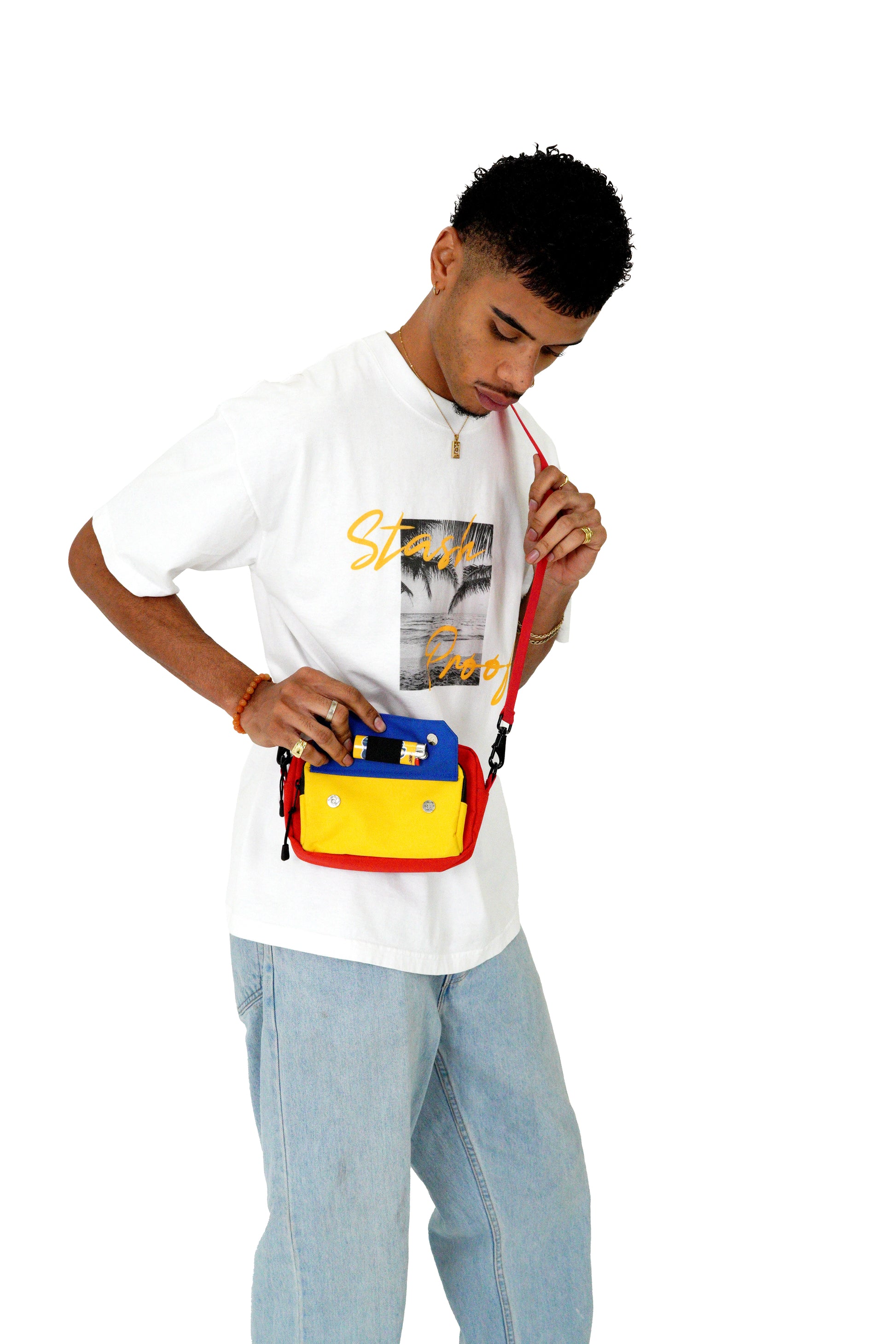 Male model on white background carrying smell proof Flip bag in Red and Yellow,