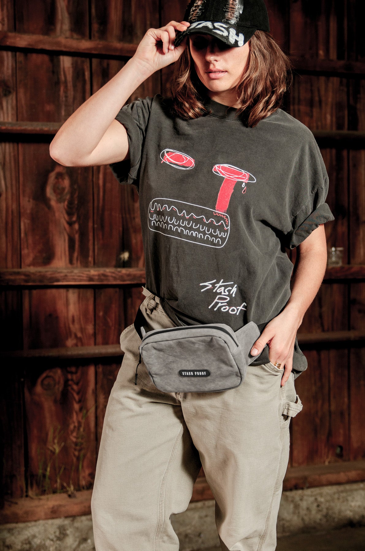 Woman in black shirt wearing grey Shadow odor proof belt bag and fanny pack by Stash Proof